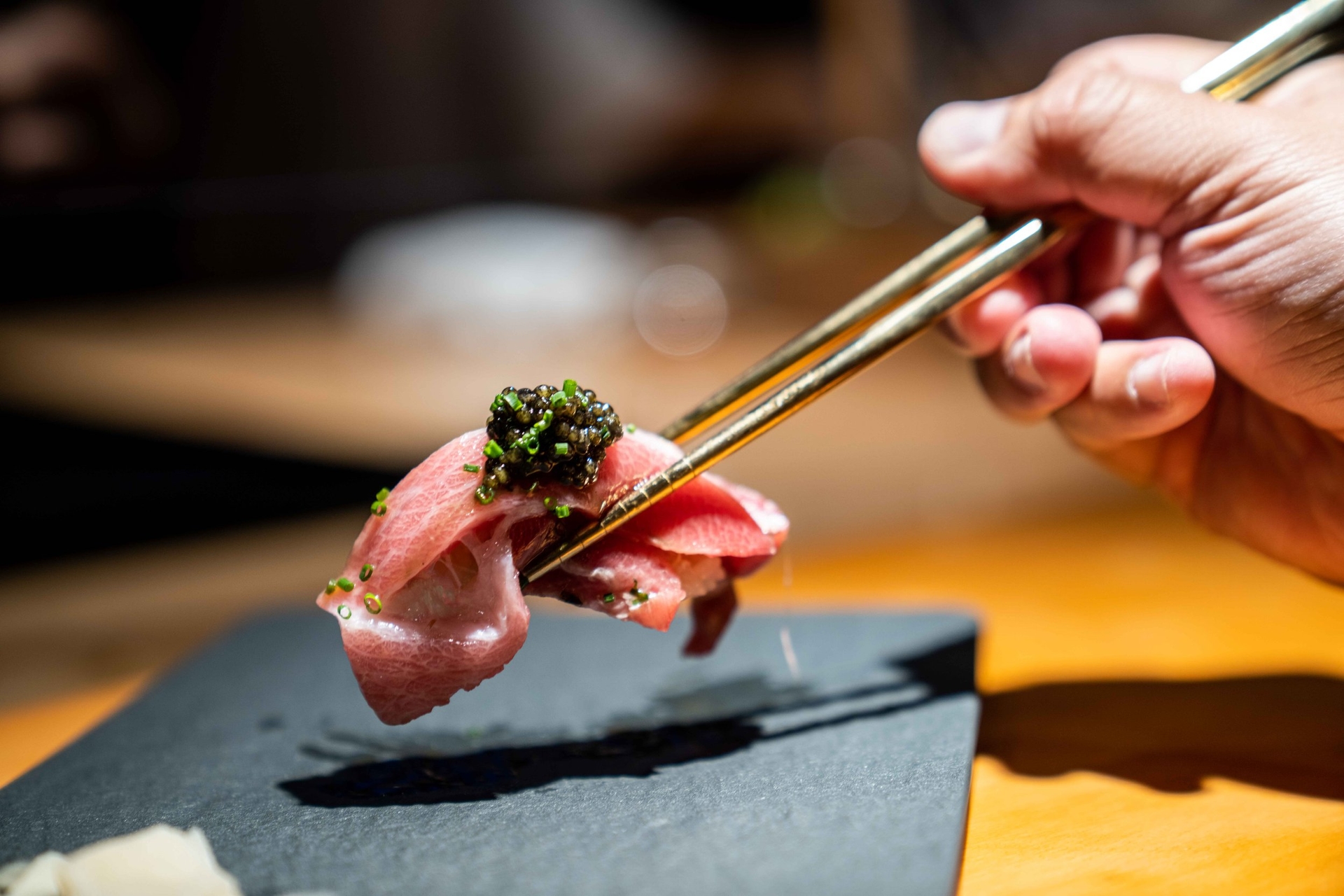 Sashimi between tow chopsticks