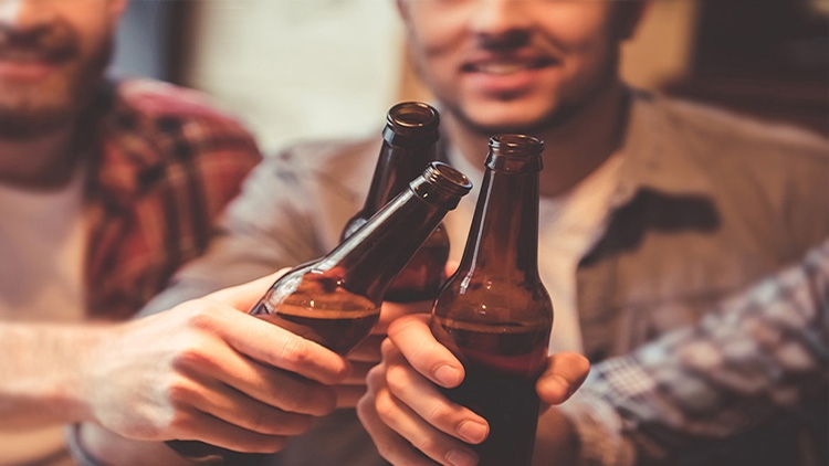 3 men sharing bottled alcohol free beer 